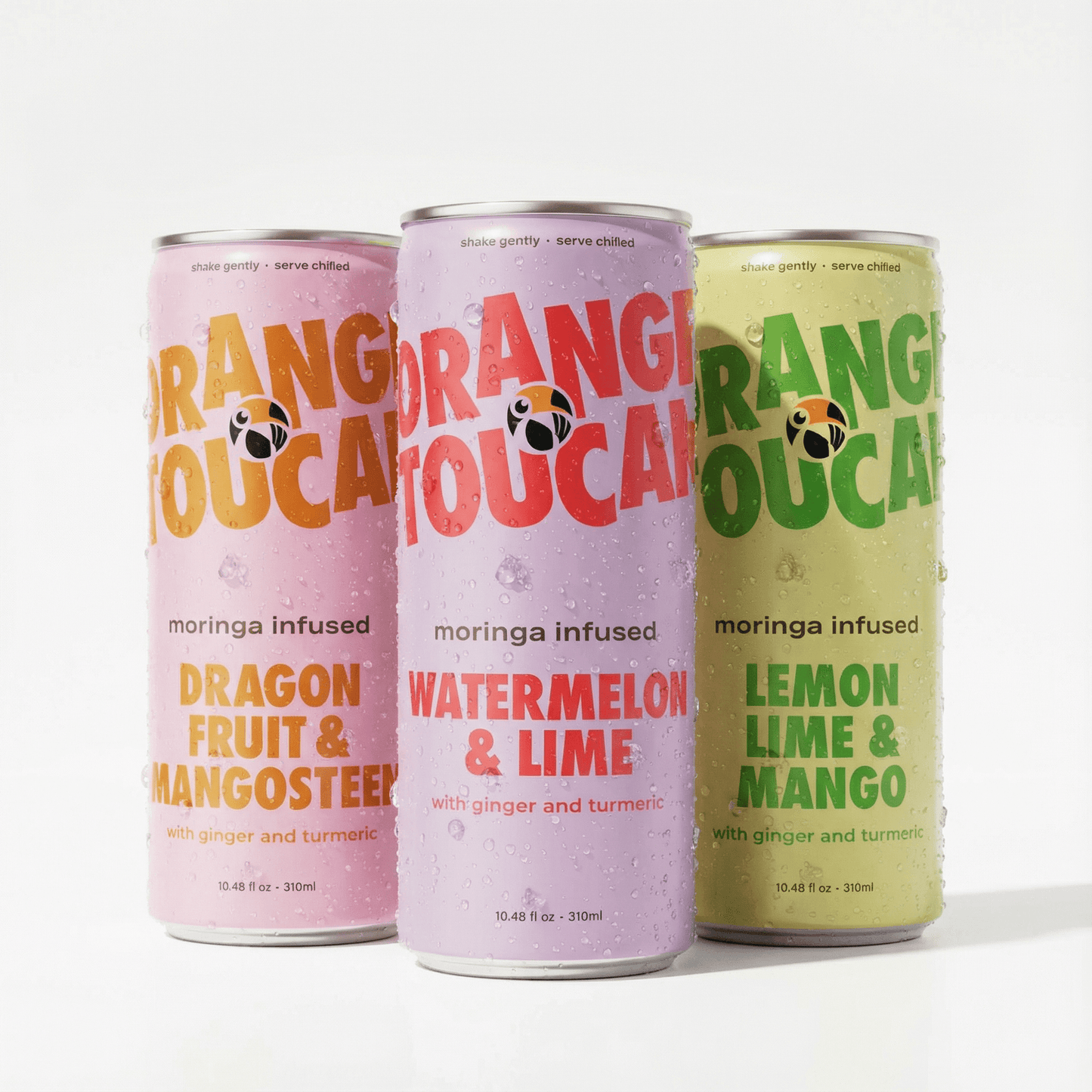 Three different flavored Orange Toucan drinks, containing moringa, ginger, and turmeric, on a white background