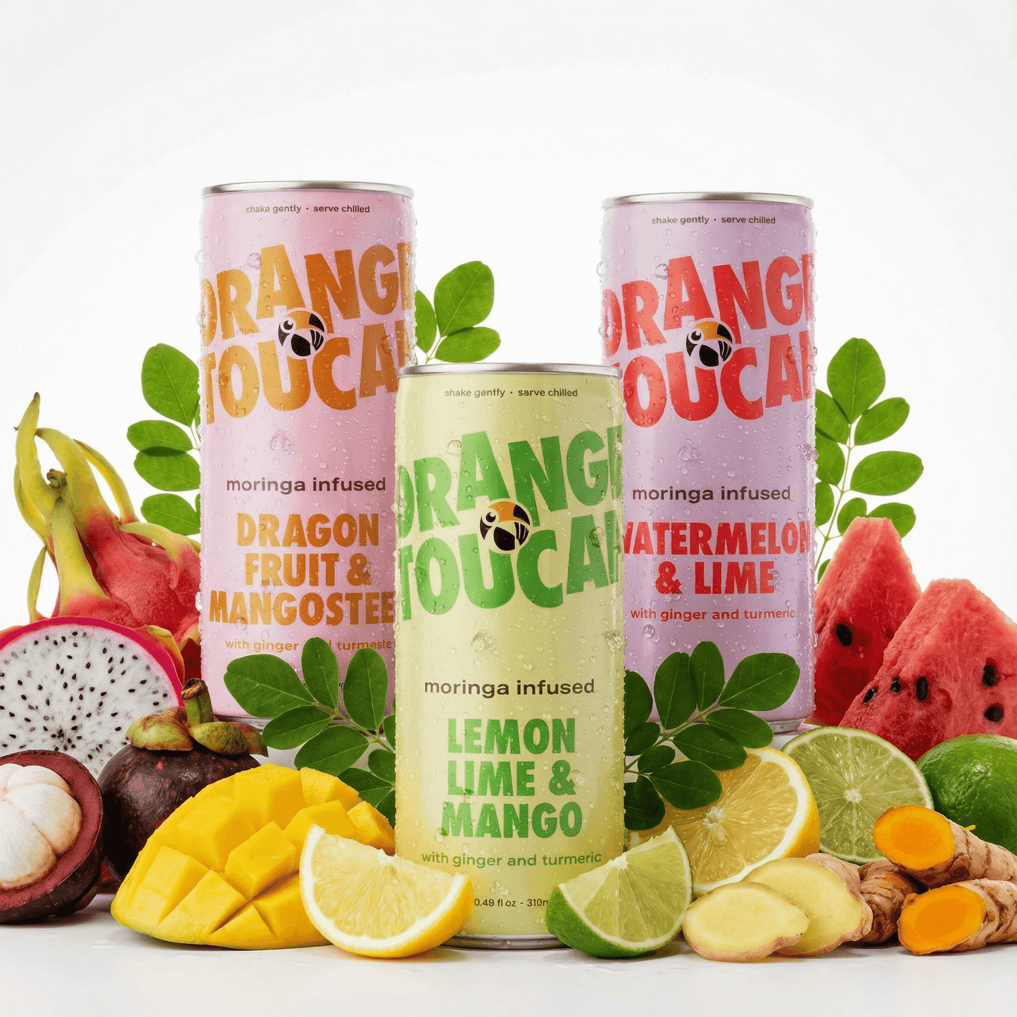 Three cans of Orange Toucan drinks with fruit and leaves on a white background