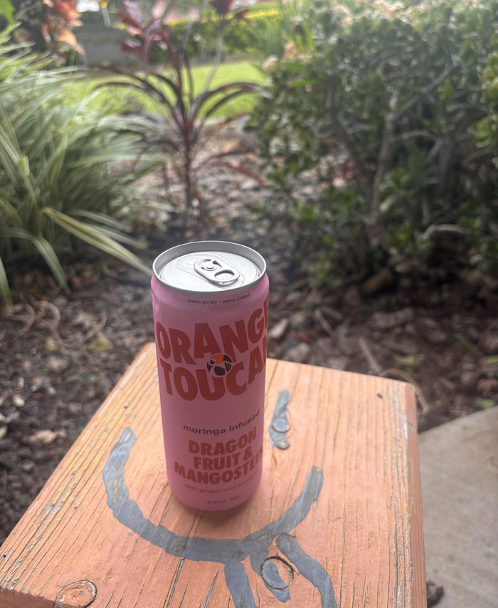 A can of Dragon Fruit & Mangosteen on a bench