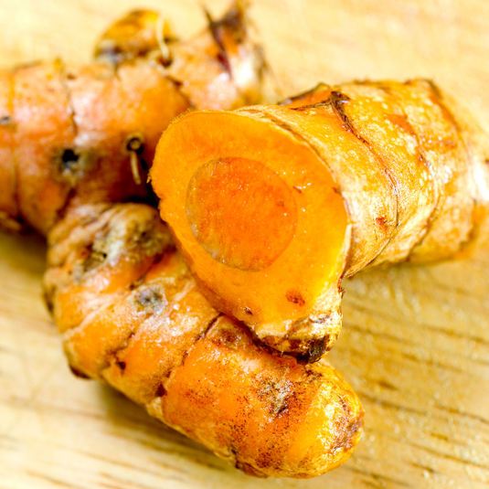 Close-up of turmeric roots on a wooden surface